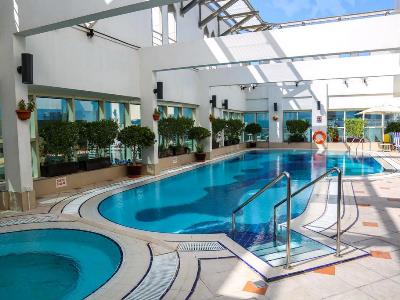 outdoor pool - hotel majlis grand mercure residence - abu dhabi, united arab emirates