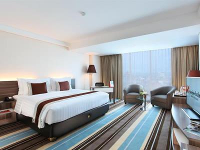 deluxe room - hotel swiss-belhotel makassar - makassar, indonesia